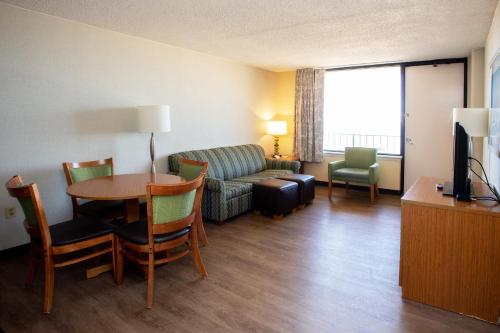 a living room with a couch and a table at The Barclay Towers Hotel and Resort in Virginia Beach