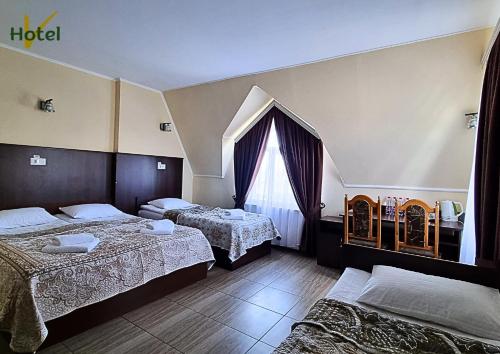 a hotel room with two beds and a window at Готель "Валерія" in Novoselytsya