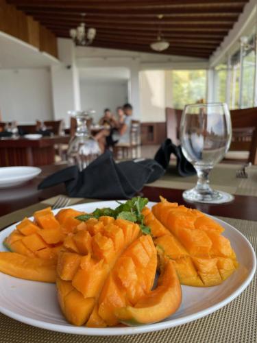 a white plate of fruit on a table at Bellwood Hills Resort & Spa in Kandy