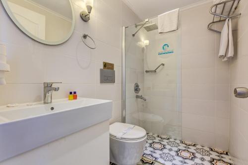 a bathroom with a shower and a toilet and a sink at Monta Verde Hotel & Villas in Oludeniz