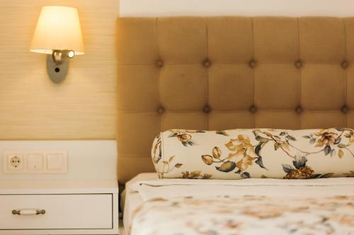 a bed with a pillow and a lamp on it at Monta Verde Hotel & Villas in Oludeniz
