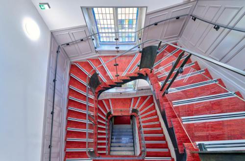 a spiral staircase in a building with red bricks at Adonis Hotel Strasbourg in Strasbourg