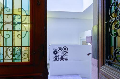 a door to a room with a gate and a window at Adonis Hotel Strasbourg in Strasbourg