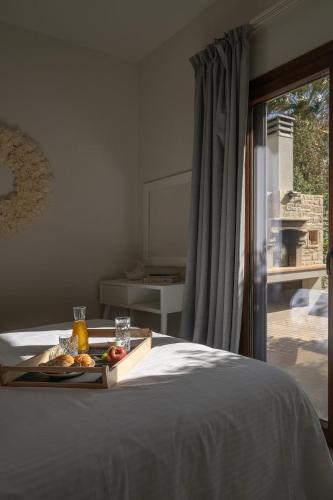 a tray of fruit on a bed in a bedroom at Diamond Dream 4 in Kalamaki
