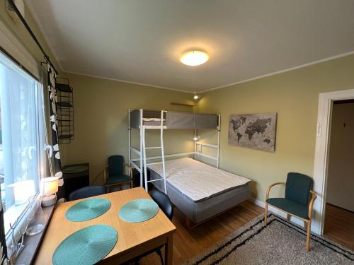 a bedroom with a bunk bed and a table and chairs at Central, university - centralt, högskolan in Halmstad