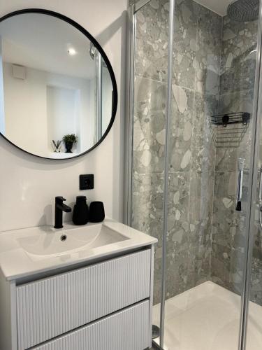 a bathroom with a sink and a shower at Sea Oasis apartment in Liepāja