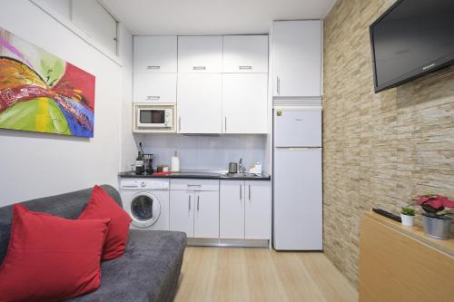 a living room with a couch and a kitchen at Half moon Piccadilly in London