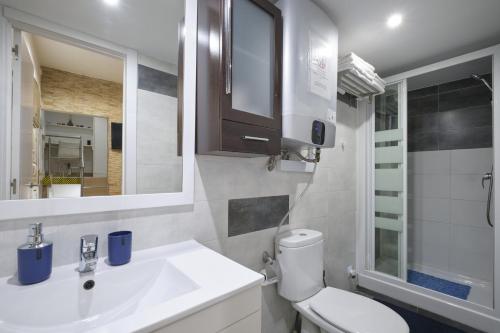 a bathroom with a sink and a toilet and a mirror at Half moon Piccadilly in London