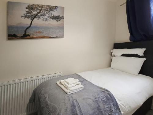 a bedroom with a bed with two towels on it at Queen House in Belper