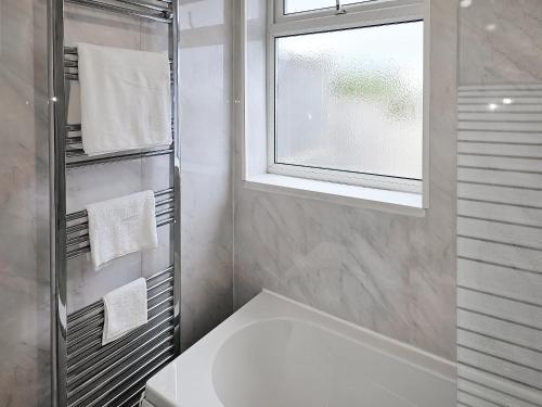 a bathroom with a white sink and a window at Queen House in Belper