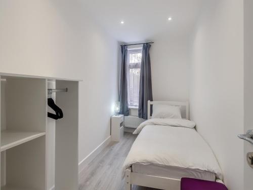 a white room with two beds and a window at No, 2 - Uk46743 in Cromer