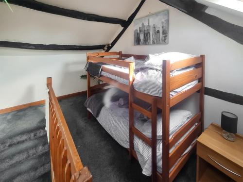 a bedroom with bunk beds in a room at The Gallery in Broughton in Furness