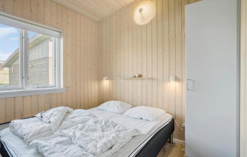 an unmade bed in a room with a window at Pet Friendly Home In Faaborg With Kitchen in Fåborg