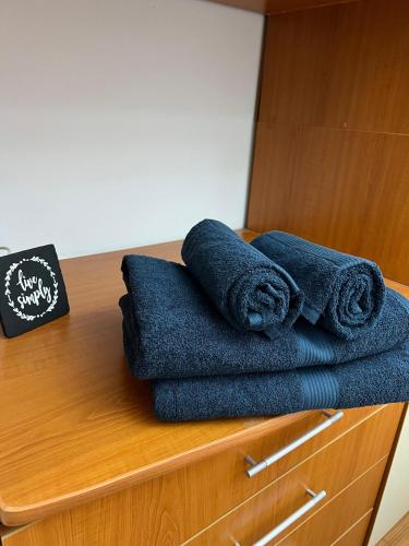 stos niebieskich ręczników na szafce w obiekcie Cozy Apartment w mieście Zalău