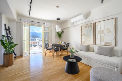 a living room with a couch and a table at Balcony Luxury Apartment Kalamata in Kalamata