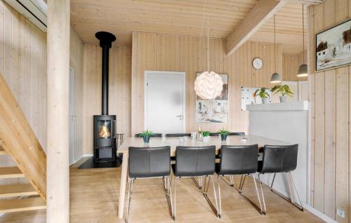 a dining room with a table and a wood stove at 4 Bedroom Nice Home In Faaborg in Fåborg