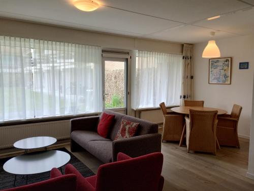 a living room with a couch and a table at BRANDING Bed by the Sea in Westkapelle