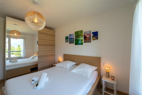 a bedroom with a large white bed and a tub at La Douce Folie - Apartment for 4 to 5 people in Sevrier in Sévrier