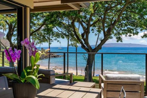 a patio with a view of the beach and the ocean at Wailea Elua Village on Ulua Beach in Wailea
