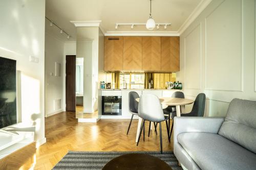 a living room with a couch and a table at VipWarsawApartments Cytryn Mennica Residence in Warsaw