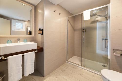 a bathroom with a shower and a sink at Palm Garden in Port d'Alcudia