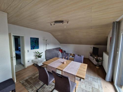 a living room with a table and a couch at Ferienwohnung Harmonie in Sulzbach