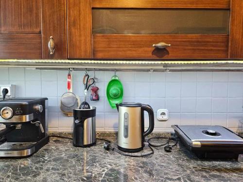 a kitchen counter with a coffee maker on a counter top at Terrazza 14, Family house in Elefsina in Eleusis