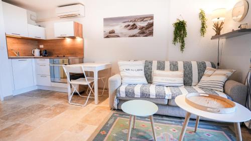 a living room with a couch and a table at Horizon Vue mer 180° in Saint-Raphaël