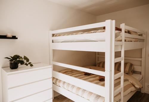 a white bunk bed in a room with a desk at Ostend Centre Bayview Apartment + Free Parking in Ostend