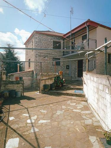 a brick house with a balcony on top of it at Άγιος Μηνάς - Αστράκα View in Ágios Minás