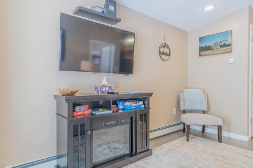 a living room with a flat screen tv on a wall at The Chena River House River Suite in Fairbanks