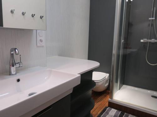 a bathroom with a sink and a shower and a toilet at Appartement à Perros-Guirec avec Vue Panoramique, Terrasse et Parking Privé - FR-1-368-271 in Perros-Guirec