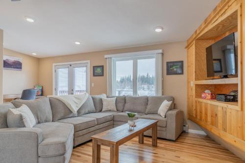 a living room with a couch and a table at The Chena River House South Suite in Fairbanks
