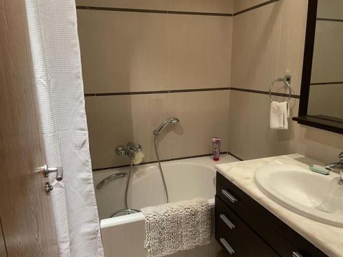 a bathroom with a bath tub and a sink at Beautiful Apartement with Lakeview in Tunis
