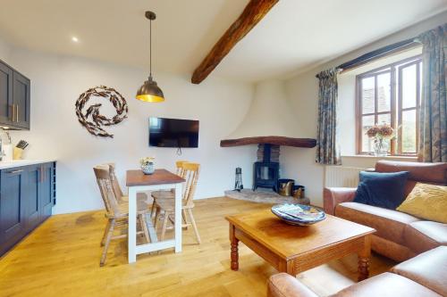 a living room with a couch and a table at Birch Cleave Stable Simonsbath in Simonsbath