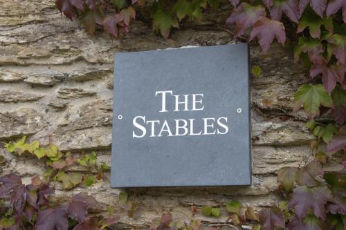 a sign on the side of a stone wall at Birch Cleave Stable Simonsbath in Simonsbath