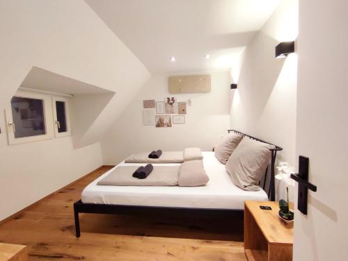 a bedroom with a bed with white sheets and pillows at Ferienwohnung Haus Mediterran max. 6 Pers. in Radolfzell am Bodensee