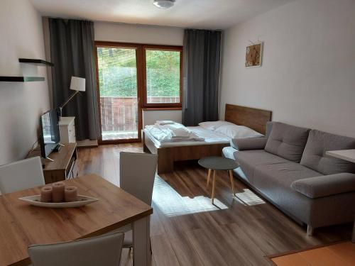 a living room with a couch and a table at Fatrapark Apartments House 2 in Ružomberok