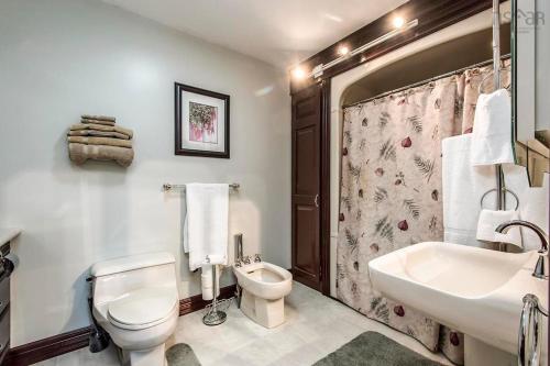 a white bathroom with a toilet and a sink at Private Bedroom and Bathroom in Dartmouth in Halifax