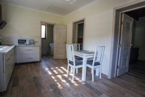 a kitchen with a table and chairs in a room at Шаян Гора in Shaian