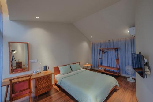 a bedroom with a bed and a dresser and a mirror at Nhà bình Homestay in Da Nang