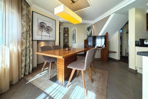 a dining room with a wooden table and chairs at Grütter Luxury Apartments in Ischgl