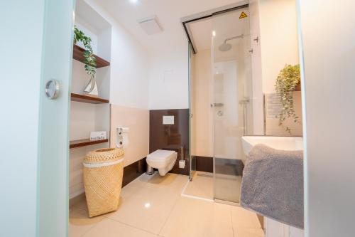 a bathroom with a toilet and a sink at App 14 Entspannen im Wellengang! in Dranske