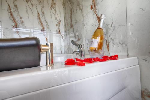 a bottle of wine sitting on top of a sink at Family Hotel The View & SPA in Tsigov Chark