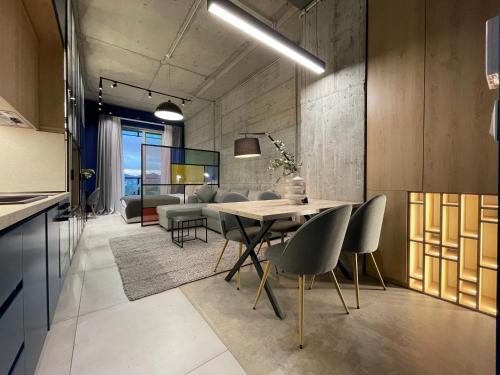 a kitchen and dining room with a table and chairs at Ambassador Skyline Apartments in Tirana