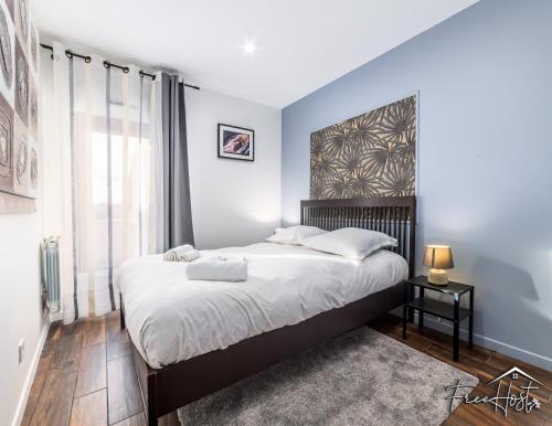 a bedroom with a large bed and a large window at Marvel House - Disneyland 5min, Private Parking, Terrace in Magny-le-Hongre