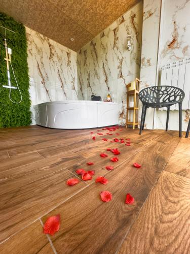 a room with red rose petals on the floor at Family Hotel The View & SPA in Tsigov Chark