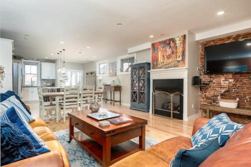 a living room with a couch and a fireplace at Heart of Downtown Newburyport Urban Loft Living in Newburyport