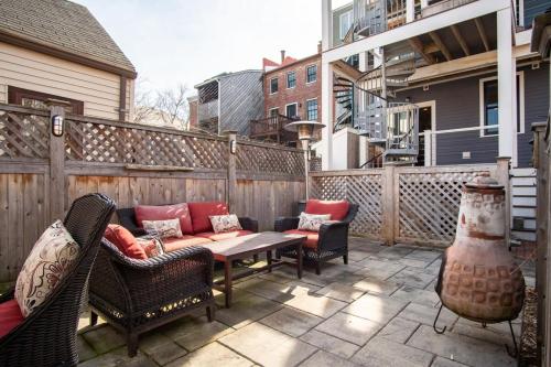 a patio with a table and chairs on a balcony at Heart of Downtown Newburyport Urban Loft Living in Newburyport