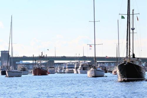 a group of boats docked in a harbor with a bridge at Heart of Downtown Newburyport Urban Loft Living in Newburyport